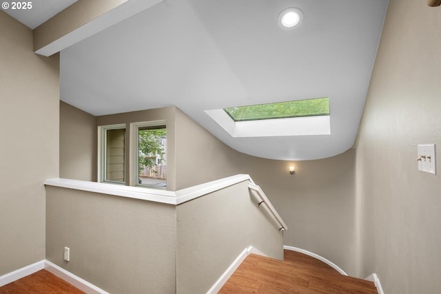 1771 NW 143rd Ave Unit 38, Portland, OR 97229 - staircase with a skylight, wood finished floors, and vaulted ceiling