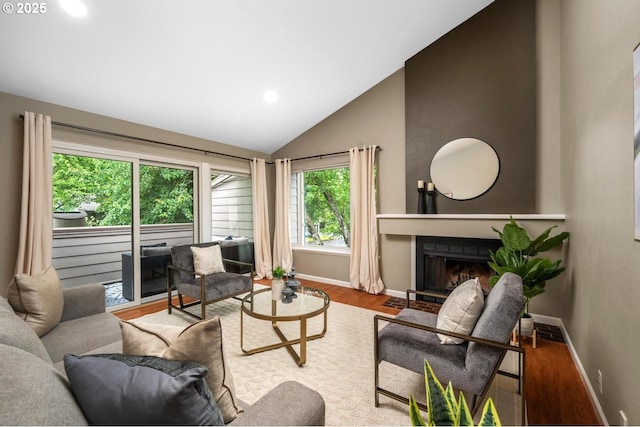 1771 NW 143rd Ave Unit 38, Portland, OR 97229 - living area featuring vaulted ceiling, a fireplace with flush hearth, wood finished floors, and recessed lighting