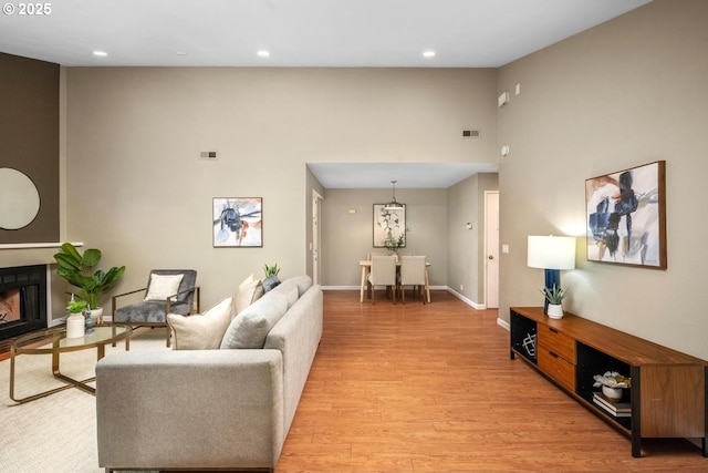 1771 NW 143rd Ave Unit 38, Portland, OR 97229 - living area with light wood-type flooring, recessed lighting, a high ceiling, and a fireplace