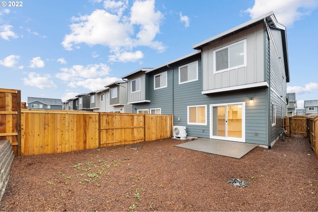 rear view of property with ac unit and a patio area