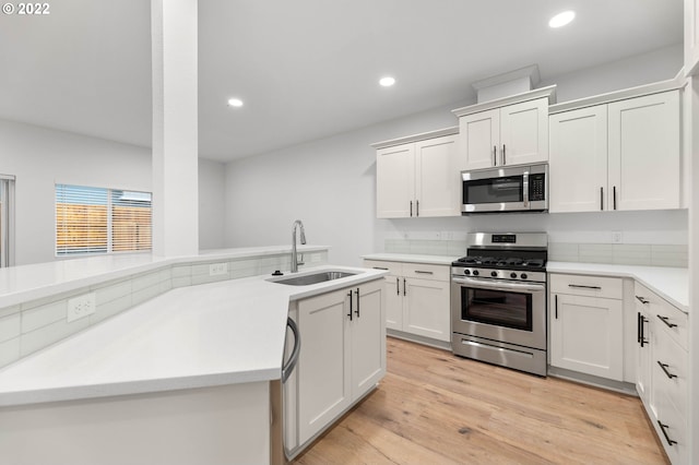 kitchen featuring appliances with stainless steel finishes, sink, and white cabinets