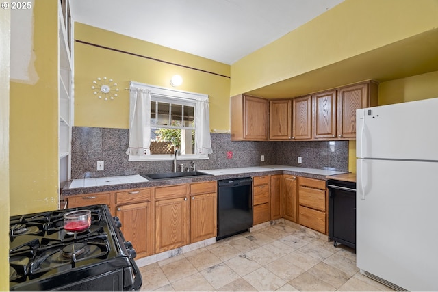 kitchen featuring tasteful backsplash, tile countertops, black appliances, and a sink