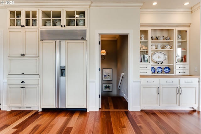 2030 W 34th Ave, Eugene, OR 97405 - kitchen featuring paneled built in fridge, ornamental molding, wood finished floors, glass insert cabinets, and recessed lighting