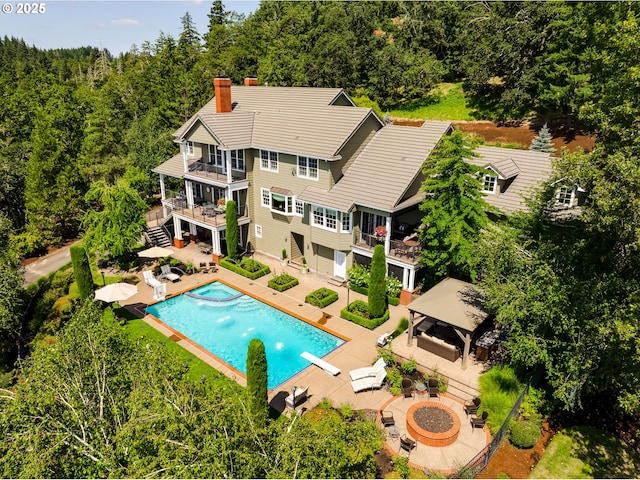 2030 W 34th Ave, Eugene, OR 97405 - rear view of house with a gazebo, a fire pit, a balcony, a patio, and a chimney