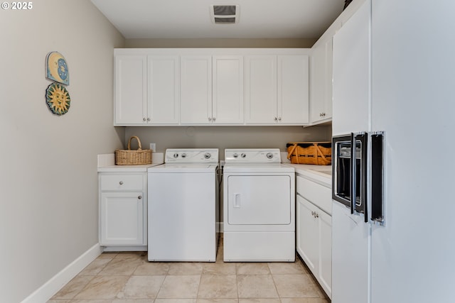 2030 W 34th Ave, Eugene, OR 97405 - laundry area with washer and dryer, cabinet space, baseboards, and light tile patterned flooring