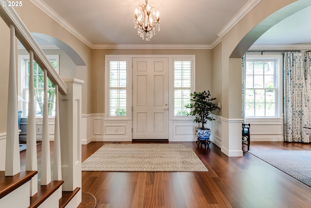 2030 W 34th Ave, Eugene, OR 97405 - entryway with arched walkways, dark wood-style floors, a decorative wall, crown molding, and a wainscoted wall
