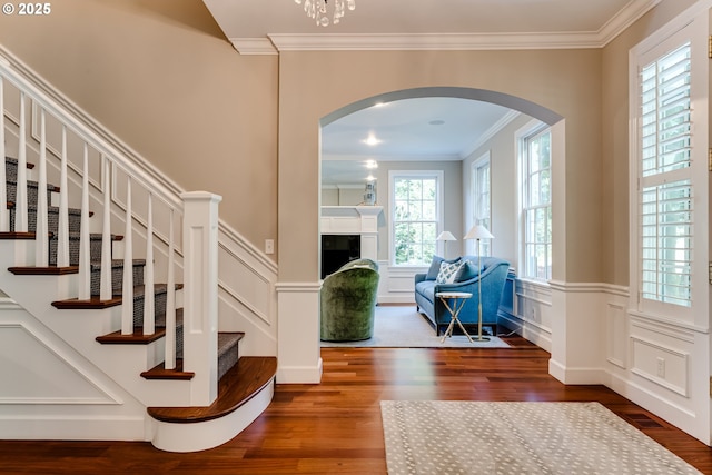 2030 W 34th Ave, Eugene, OR 97405 - entrance foyer featuring arched walkways, wood finished floors, ornamental molding, a decorative wall, and stairs