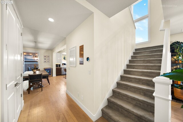 stairway with hardwood / wood-style floors