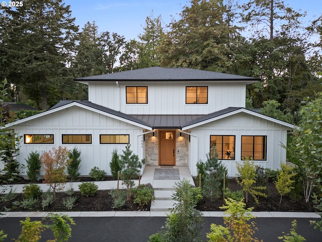 modern farmhouse with a standing seam roof, board and batten siding, metal roof, and roof with shingles