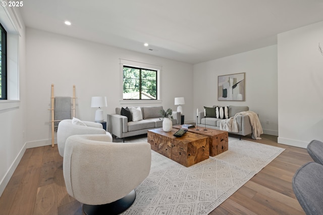 living room with wood finished floors, recessed lighting, and baseboards