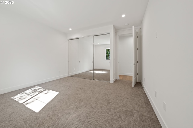 unfurnished bedroom with recessed lighting, carpet floors, a closet, and baseboards