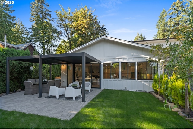 back of property featuring a patio area, board and batten siding, an outdoor living space, and a lawn