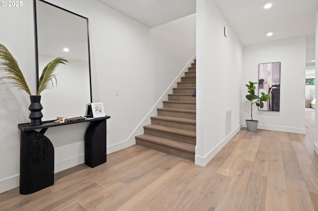 entrance foyer with light wood-style flooring, stairway, recessed lighting, and baseboards