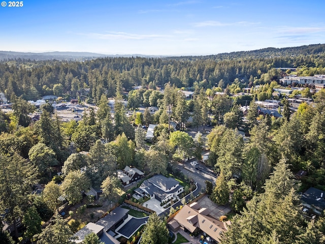 view of property location featuring a forest