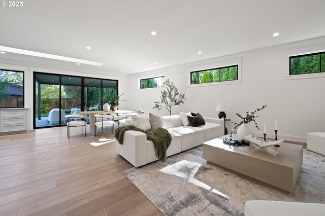 living area featuring light wood finished floors and recessed lighting