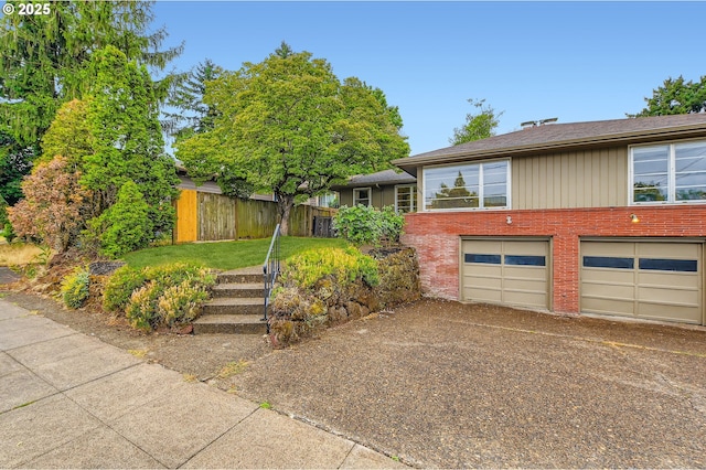 4645 NE 42nd Ave, Portland, OR 97218 - view of front of house with brick siding, a garage, and driveway