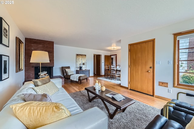 4645 NE 42nd Ave, Portland, OR 97218 - living area featuring light wood-style flooring and a brick fireplace