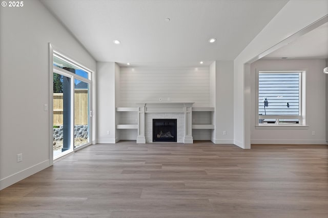14196 SE Iseli Ln, Clackamas, OR 97015 - unfurnished living room with recessed lighting, a fireplace, and wood finished floors