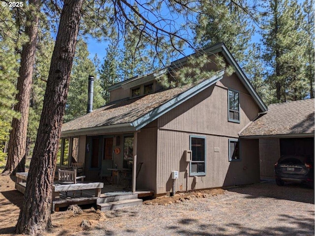 70710 Steeple Bush, Sisters, OR 97759 - rear view of house with a shingled roof and covered porch