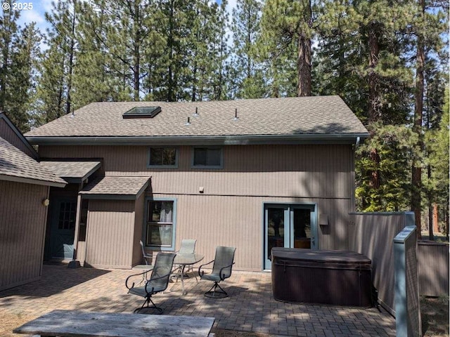 70710 Steeple Bush, Sisters, OR 97759 - back of house with a hot tub, a patio, and roof with shingles
