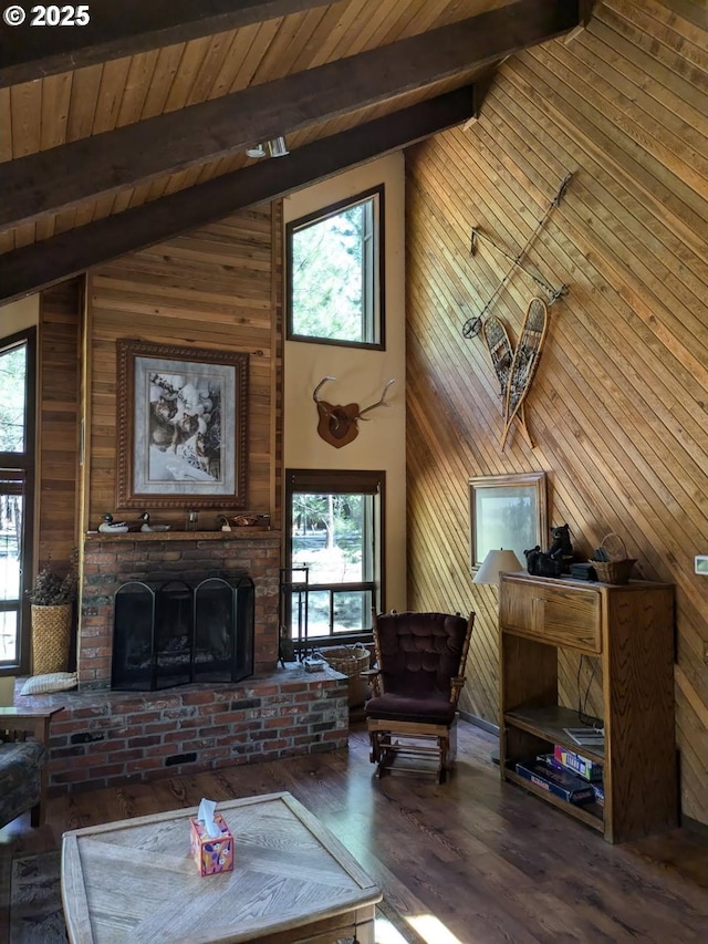 70710 Steeple Bush, Sisters, OR 97759 - living room with wooden walls, beam ceiling, a brick fireplace, healthy amount of natural light, and high vaulted ceiling