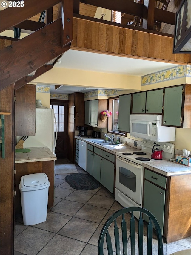 70710 Steeple Bush, Sisters, OR 97759 - kitchen with white appliances, a sink, light countertops, tile patterned flooring, and green cabinetry