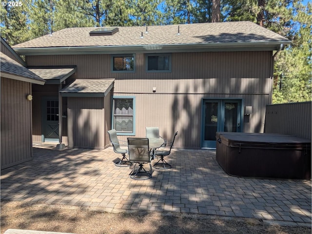 70710 Steeple Bush, Sisters, OR 97759 - rear view of property with a hot tub, a patio area, roof with shingles, and outdoor dining area