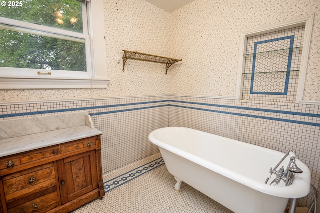2822 Crocker Rd, Eugene, OR 97404 - full bathroom featuring a soaking tub, wainscoting, wallpapered walls, and tile walls