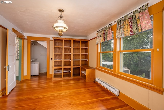 2822 Crocker Rd, Eugene, OR 97404 - unfurnished room featuring a baseboard heating unit, wood finished floors, washer / clothes dryer, and baseboard heating