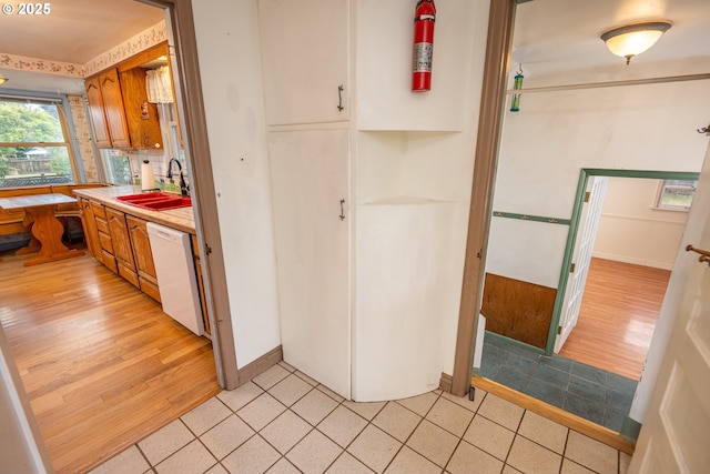 2822 Crocker Rd, Eugene, OR 97404 - kitchen featuring dishwasher, brown cabinetry, light countertops, and light wood-type flooring