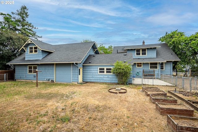 2822 Crocker Rd, Eugene, OR 97404 - back of property with a vegetable garden, a shingled roof, and a chimney