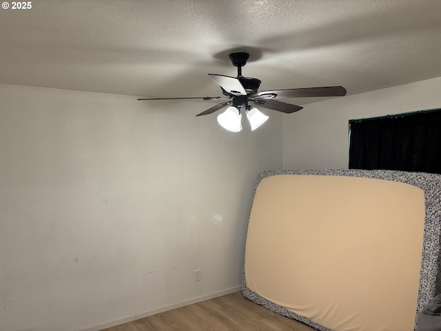 145 Donald Ter, Myrtle Creek, OR 97457 - unfurnished bedroom with light wood finished floors, a textured ceiling, ceiling fan, and baseboards