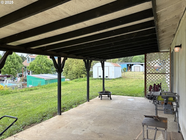 145 Donald Ter, Myrtle Creek, OR 97457 - view of patio / terrace with a storage shed, an outdoor structure, and an outdoor fire pit