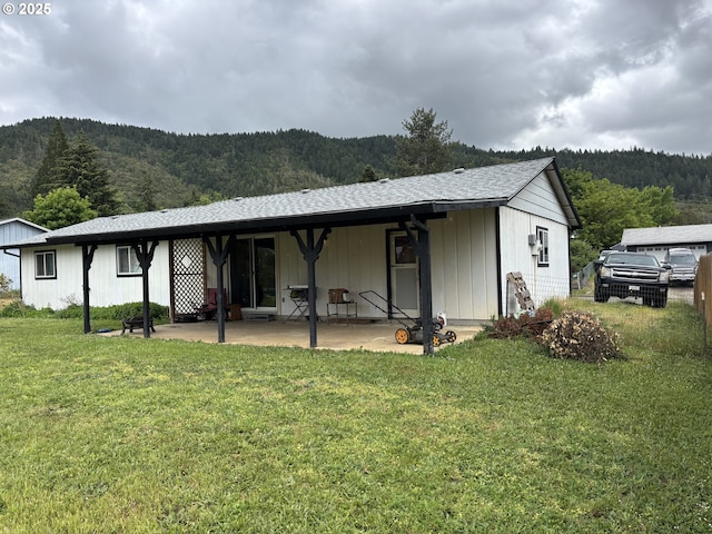 145 Donald Ter, Myrtle Creek, OR 97457 - rear view of property featuring a wooded view, a lawn, and a patio