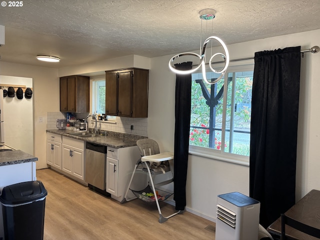 145 Donald Ter, Myrtle Creek, OR 97457 - kitchen featuring dishwasher, a sink, dark countertops, tasteful backsplash, and light wood finished floors