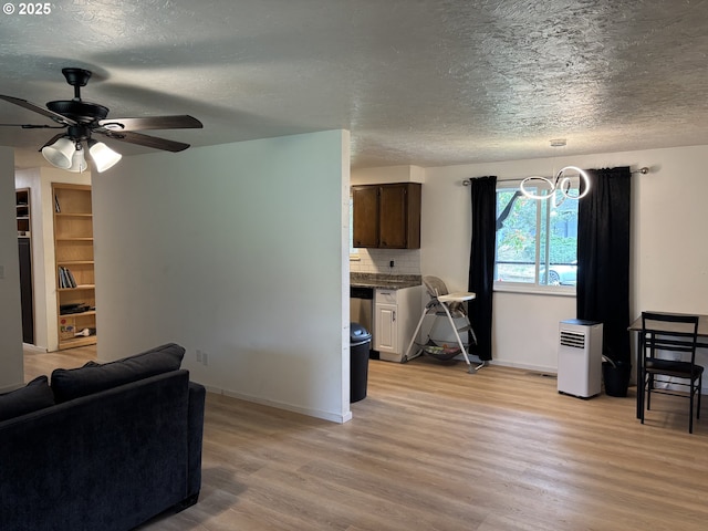 145 Donald Ter, Myrtle Creek, OR 97457 - living room with light wood-style flooring, a textured ceiling, a ceiling fan, and baseboards