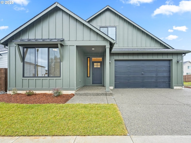 modern inspired farmhouse featuring an attached garage, board and batten siding, a standing seam roof, driveway, and a front lawn