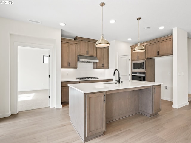 17019 NE 82nd St, Vancouver, WA 98682 - kitchen with gas stovetop, stainless steel microwave, a sink, black oven, and under cabinet range hood