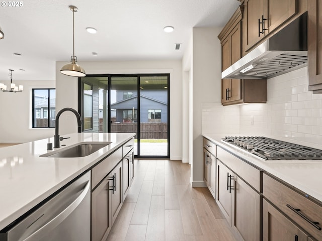 17019 NE 82nd St, Vancouver, WA 98682 - kitchen featuring light wood-style flooring, under cabinet range hood, a sink, light countertops, and appliances with stainless steel finishes