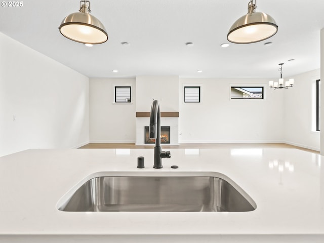 17019 NE 82nd St, Vancouver, WA 98682 - kitchen with decorative light fixtures, recessed lighting, open floor plan, a sink, and a lit fireplace