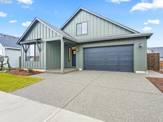 modern farmhouse featuring driveway, a shingled roof, a garage, and board and batten siding