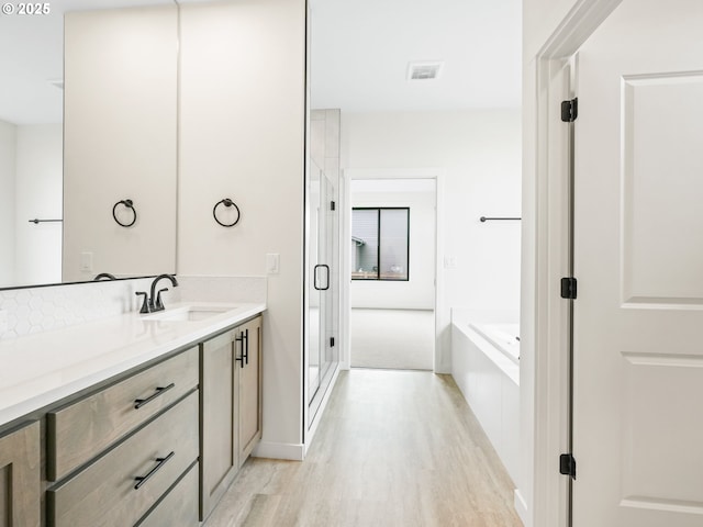 17019 NE 82nd St, Vancouver, WA 98682 - full bathroom with vanity, a stall shower, wood finished floors, and a bath