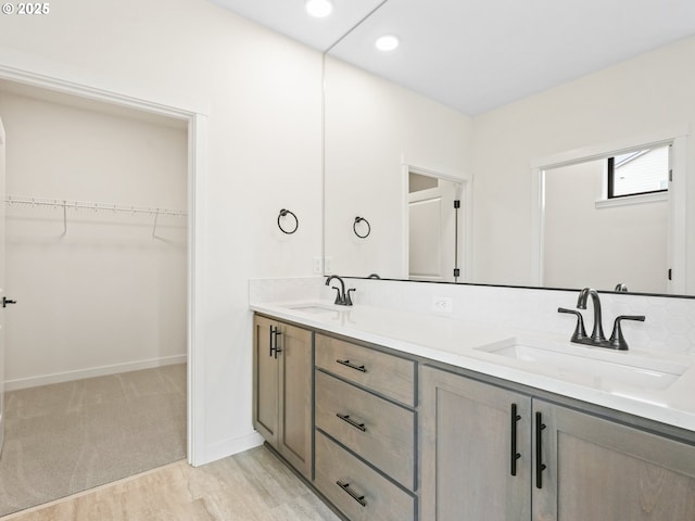 17019 NE 82nd St, Vancouver, WA 98682 - full bathroom featuring double vanity, a sink, a walk in closet, and baseboards