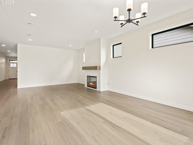 17019 NE 82nd St, Vancouver, WA 98682 - unfurnished living room featuring light wood-style floors, recessed lighting, baseboards, and a glass covered fireplace
