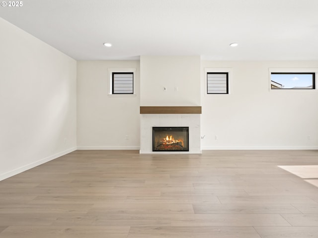 17019 NE 82nd St, Vancouver, WA 98682 - unfurnished living room featuring light wood-style flooring, baseboards, and a tiled fireplace