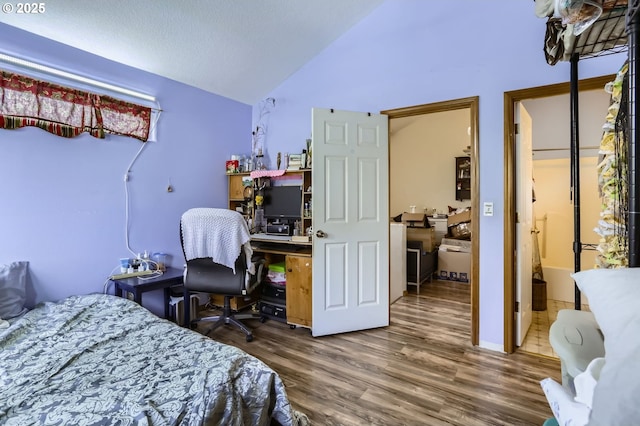 bedroom featuring wood finished floors and vaulted ceiling