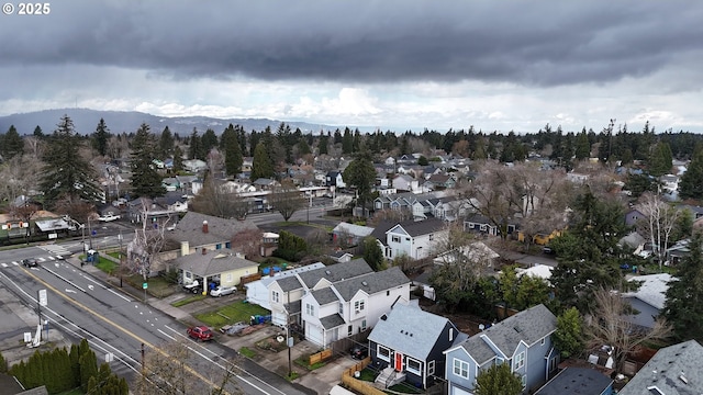 birds eye view of property with a mountain view and a residential view