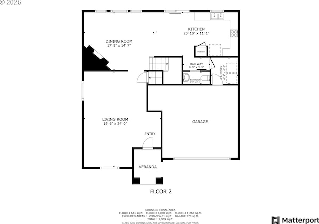 unfurnished living room with carpet, stairway, and plenty of natural light
