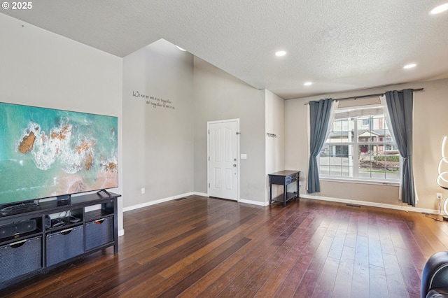 entrance foyer with hardwood / wood-style floors, a textured ceiling, and baseboards