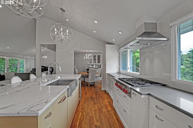 7100 SW Willowmere Dr, Portland, OR 97225 - kitchen with a chandelier, stainless steel gas stovetop, a sink, wood finished floors, and plenty of natural light